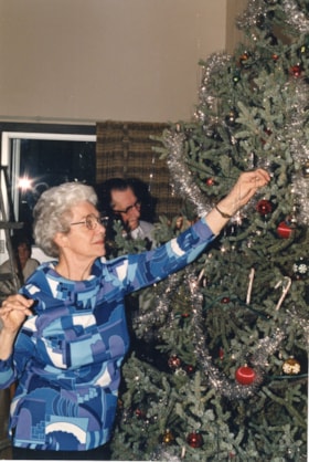 Alice Filkin decorating Christmas tree. (Images are provided for educational and research purposes only. Other use requires permission, please contact the Museum.) thumbnail