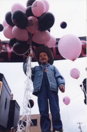 Boy with balloons at Fall Fair. (Images are provided for educational and research purposes only. Other use requires permission, please contact the Museum.) thumbnail