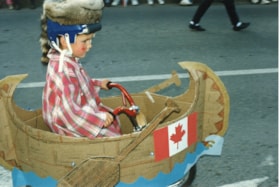 Boy in 'canoe' in 75th Homecoming parade. (Images are provided for educational and research purposes only. Other use requires permission, please contact the Museum.) thumbnail