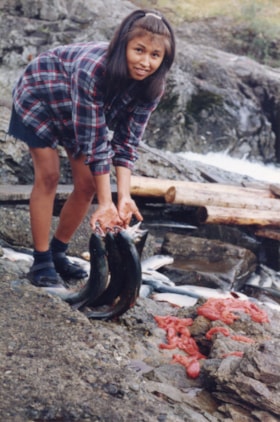 Girl with salmon at Widzin Kwah Canyon. (Images are provided for educational and research purposes only. Other use requires permission, please contact the Museum.) thumbnail