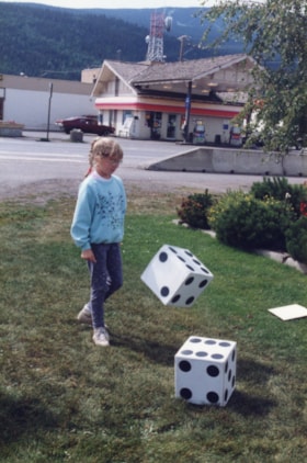Girl rolling giant 'Smithopoly' dice. (Images are provided for educational and research purposes only. Other use requires permission, please contact the Museum.) thumbnail