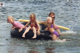 Girls on inner tube in Tyhee Lake. (Images are provided for educational and research purposes only. Other use requires permission, please contact the Museum.) thumbnail