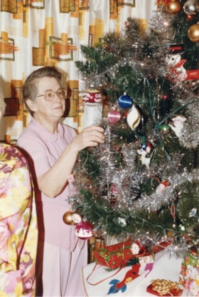 Woman decorating Christmas tree at Bulkley Lodge. (Images are provided for educational and research purposes only. Other use requires permission, please contact the Museum.) thumbnail