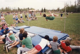 High jumping at track and field meet. (Images are provided for educational and research purposes only. Other use requires permission, please contact the Museum.) thumbnail