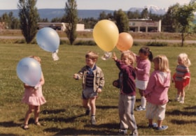 Children with balloons at Chandler Park. (Images are provided for educational and research purposes only. Other use requires permission, please contact the Museum.) thumbnail
