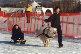 Dog pulling girl on sled, Cabin Fever Days. (Images are provided for educational and research purposes only. Other use requires permission, please contact the Museum.) thumbnail