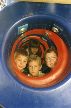 Kids peeking out of jungle gym. (Images are provided for educational and research purposes only. Other use requires permission, please contact the Museum.) thumbnail