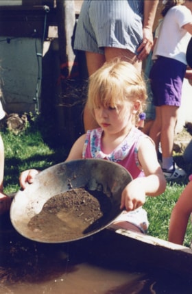 Girl panning for gold. (Images are provided for educational and research purposes only. Other use requires permission, please contact the Museum.) thumbnail