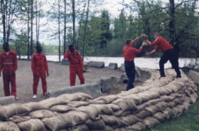 Firefighters reinforcing dyke at Eddy Park. (Images are provided for educational and research purposes only. Other use requires permission, please contact the Museum.) thumbnail