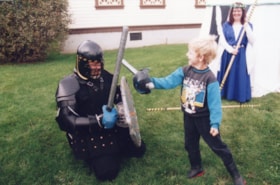 Boy and 'knight' swordfighting. (Images are provided for educational and research purposes only. Other use requires permission, please contact the Museum.) thumbnail