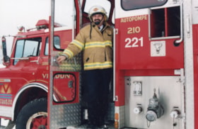 Fire chief Les Schumacher with pumper truck. (Images are provided for educational and research purposes only. Other use requires permission, please contact the Museum.) thumbnail