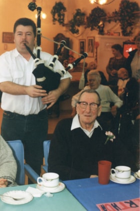 Gordon Cormier playing bagpipes for Tom Jeffrey. (Images are provided for educational and research purposes only. Other use requires permission, please contact the Museum.) thumbnail