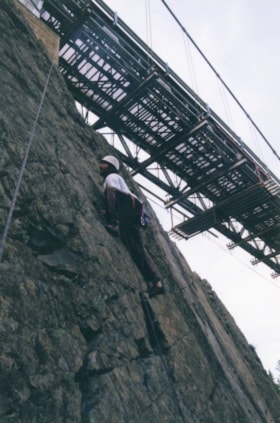 Ron Alton climbing beneath Hagwilget Bridge. (Images are provided for educational and research purposes only. Other use requires permission, please contact the Museum.) thumbnail