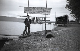 Man near Paddy Leon's boat rental sign at Topley Landing. (Images are provided for educational and research purposes only. Other use requires permission, please contact the Museum.) thumbnail