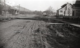Houses along unpaved road. (Images are provided for educational and research purposes only. Other use requires permission, please contact the Museum.) thumbnail