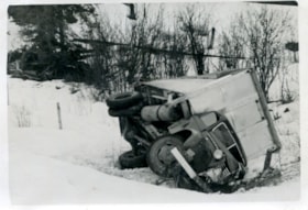 Crashed truck on side of highway. (Images are provided for educational and research purposes only. Other use requires permission, please contact the Museum.) thumbnail