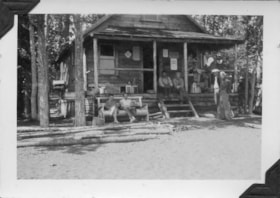 Group in front of a cabin. (Images are provided for educational and research purposes only. Other use requires permission, please contact the Museum.) thumbnail